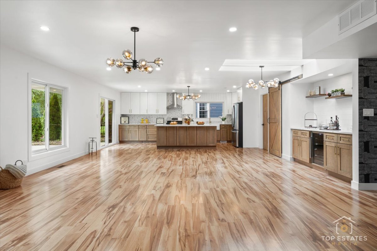 1327 Churchill Road Schaumburg, IL 60169 - Photo 24 of 71 a large white kitchen with a stove a refrigerator a sink dishwasher with a dining table and chairs with wooden floor