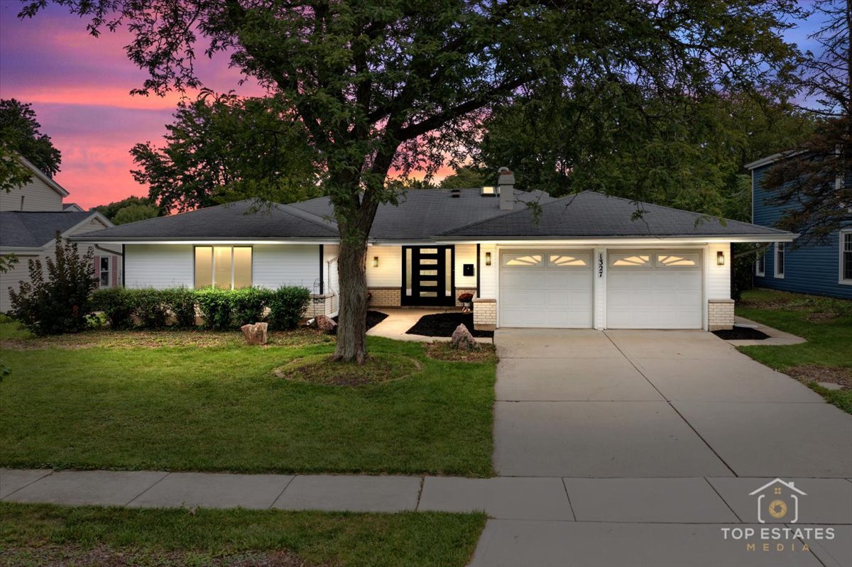 1327 Churchill Road Schaumburg, IL 60169 - Photo 3 of 71 a front view of a house with a yard and garage