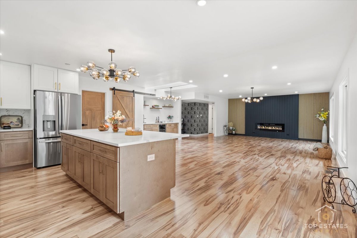 1327 Churchill Road Schaumburg, IL 60169 - Photo 32 of 71 a large kitchen with stainless steel appliances kitchen island a large counter top and wooden floors