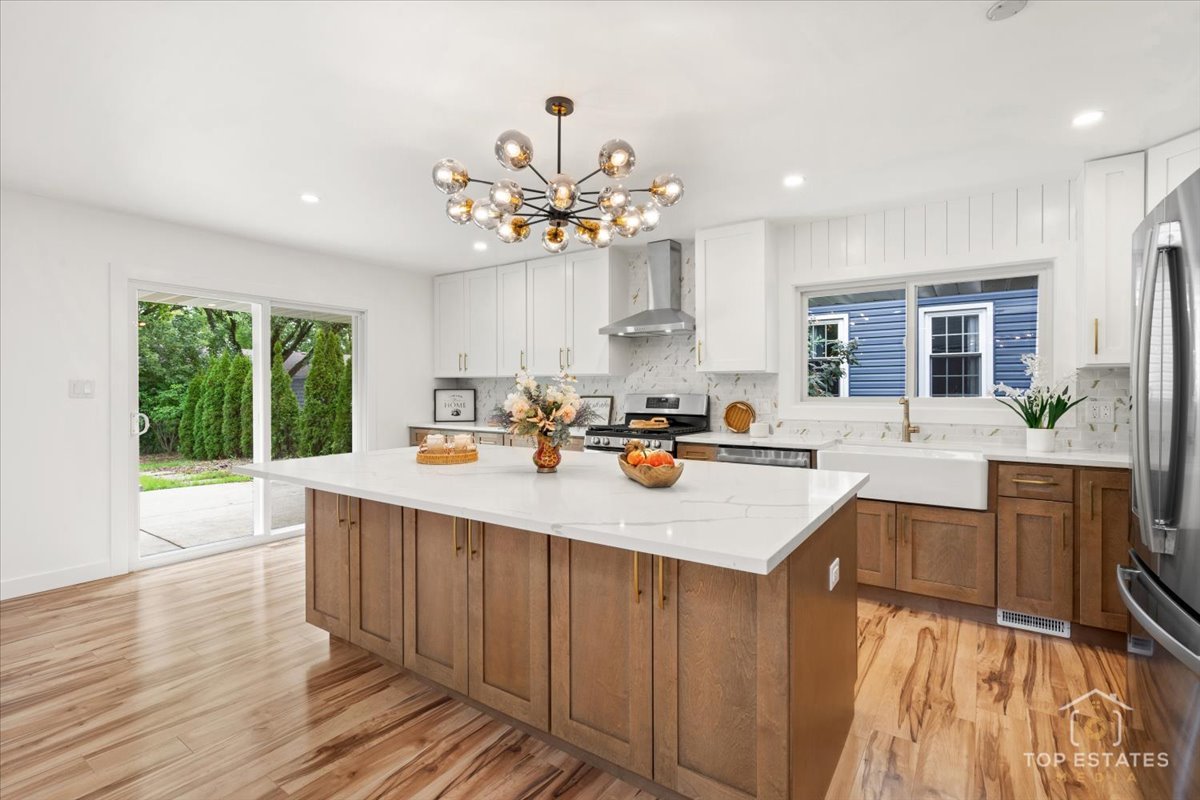 1327 Churchill Road Schaumburg, IL 60169 - Photo 36 of 71 a kitchen with a stove a sink dishwasher and a oven with wooden floor