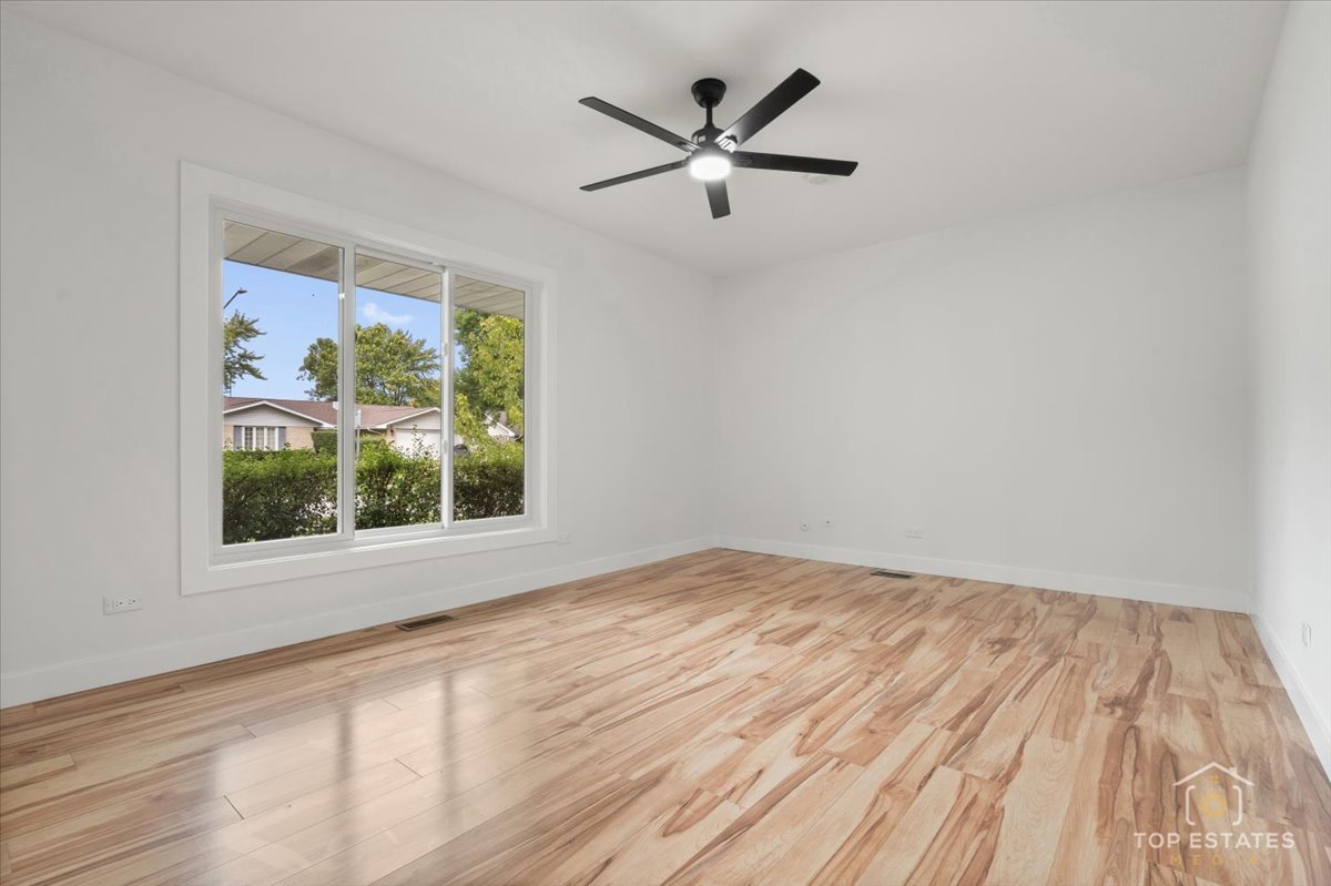 1327 Churchill Road Schaumburg, IL 60169 - Photo 45 of 71 an empty room with a window and a ceiling fan