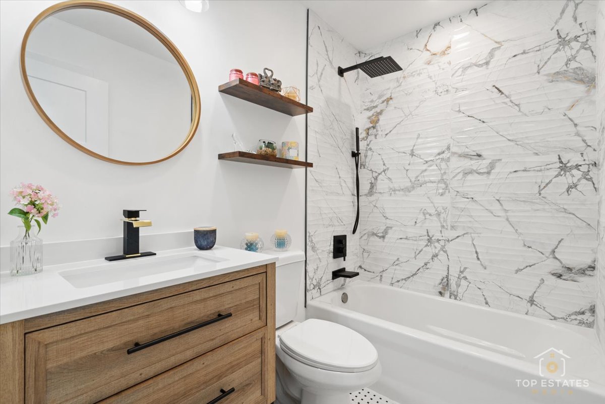 1327 Churchill Road Schaumburg, IL 60169 - Photo 48 of 71 a bathroom with a sink a toilet and a mirror