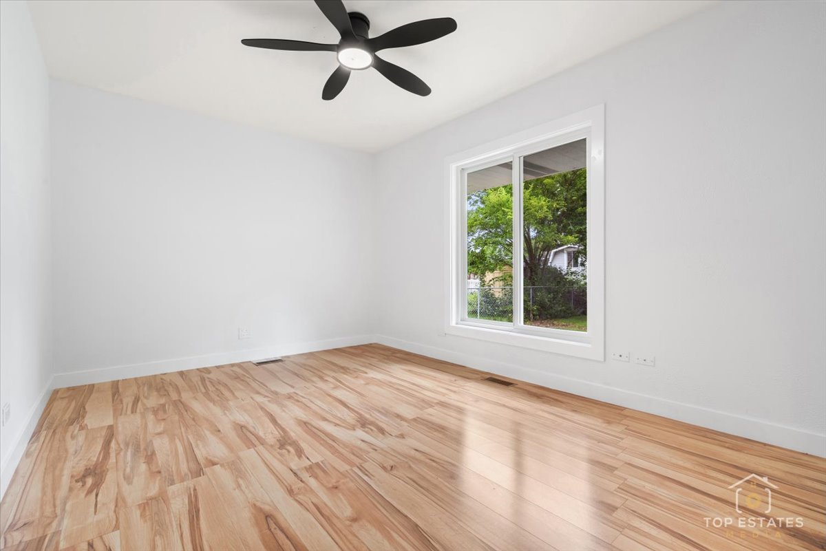 1327 Churchill Road Schaumburg, IL 60169 - Photo 53 of 71 a view of empty room with wooden floor and fan