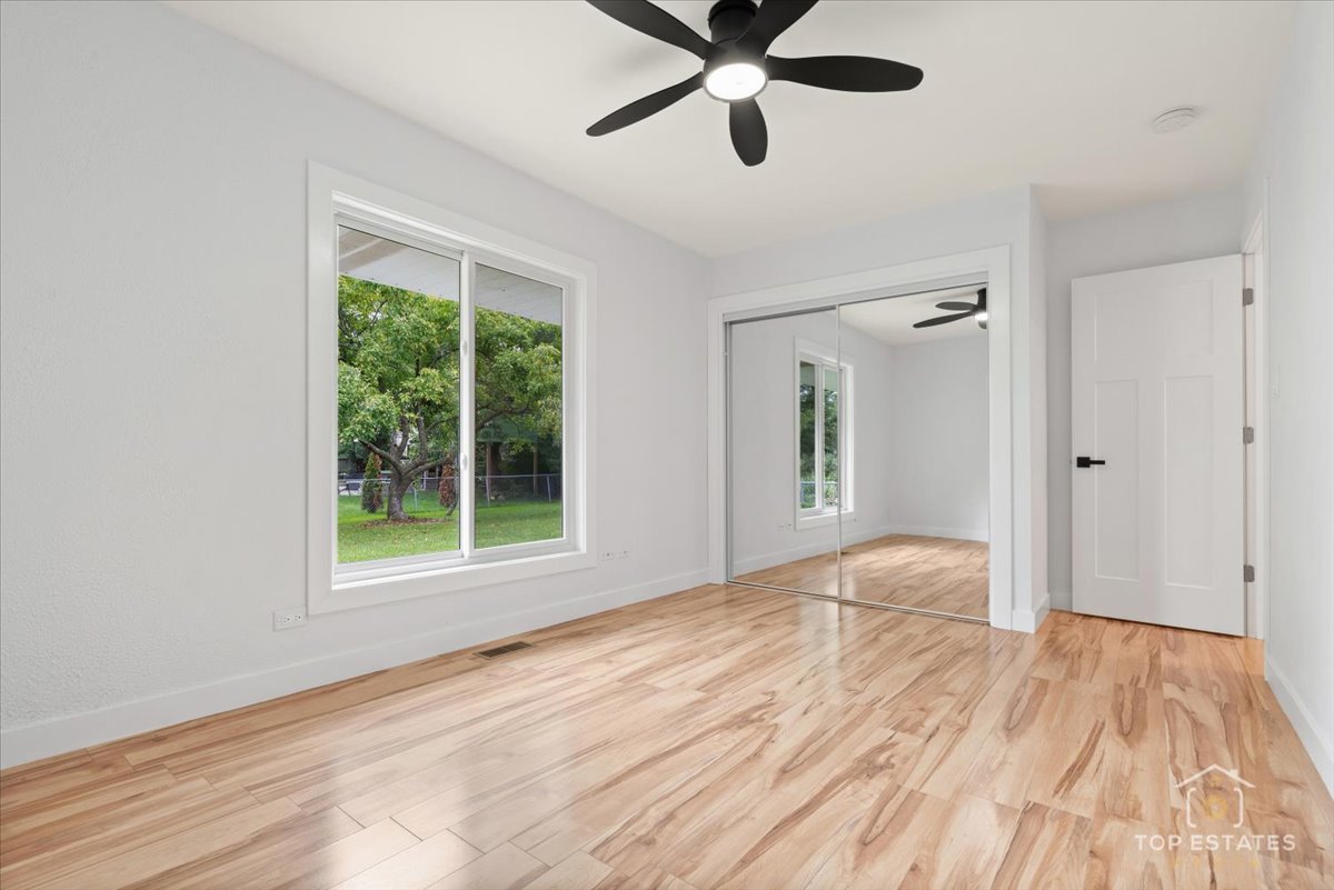 1327 Churchill Road Schaumburg, IL 60169 - Photo 54 of 71 a view of an empty room with wooden floor and a window