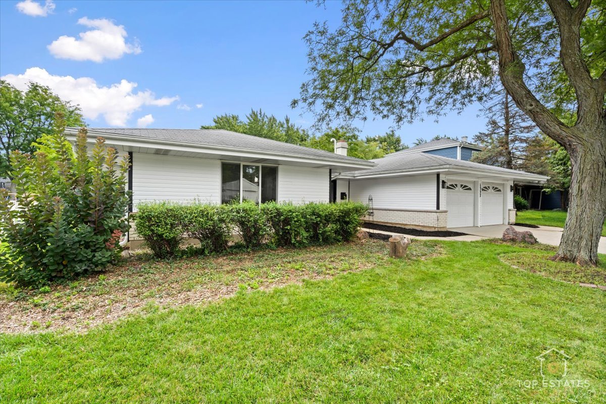1327 Churchill Road Schaumburg, IL 60169 - Photo 8 of 71 a white house that has a tree in front of the house