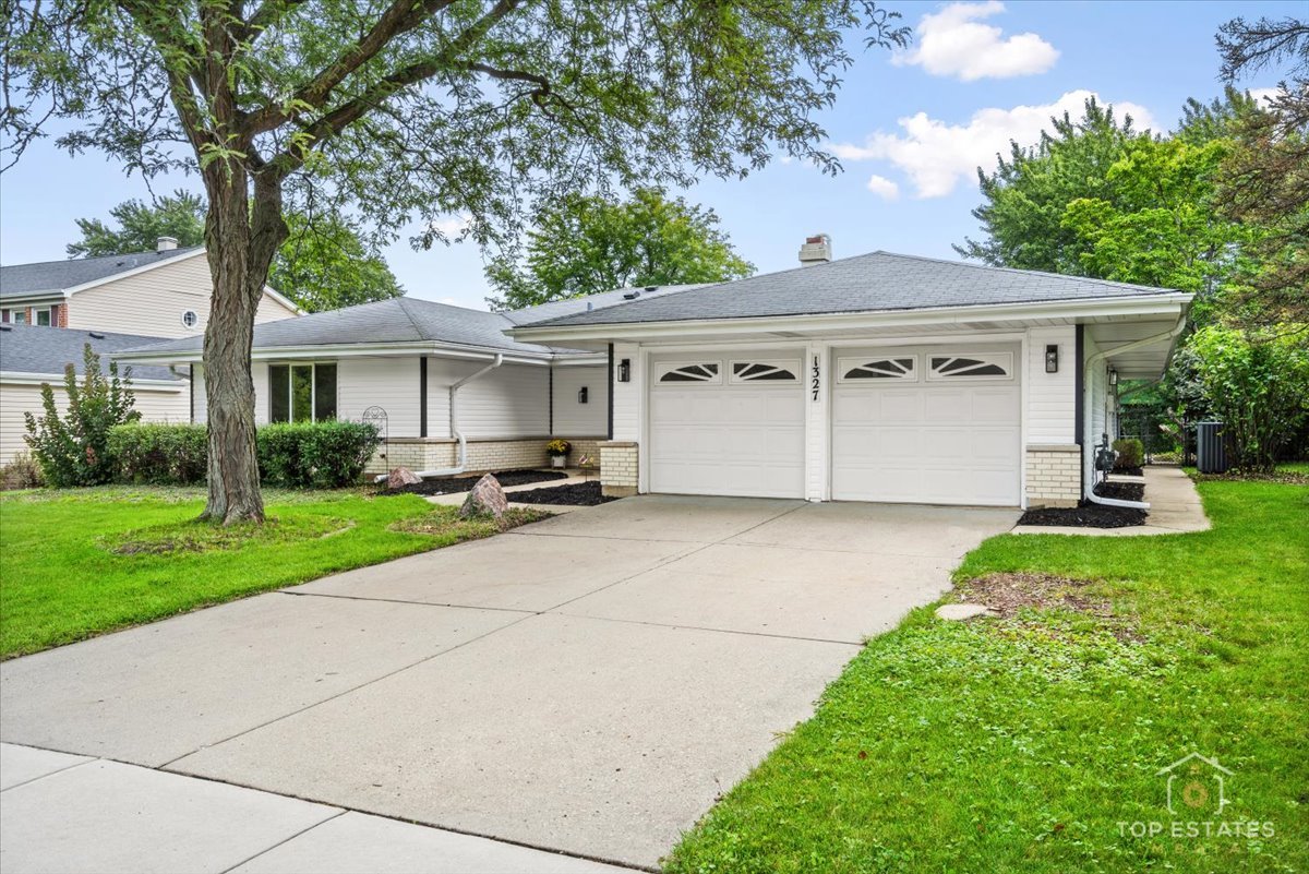 1327 Churchill Road Schaumburg, IL 60169 - Photo 9 of 71 a view of a white house with a yard