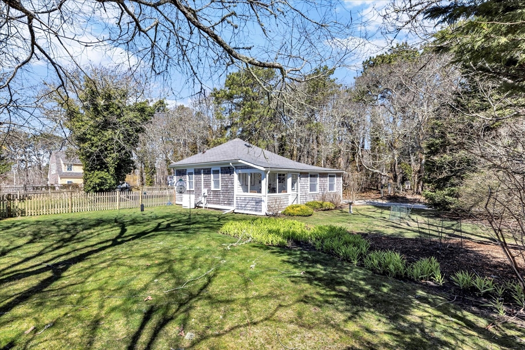 9 Jason Lane Harwich, MA 02646 - Photo 3 of 37 a front view of a house with a yard
