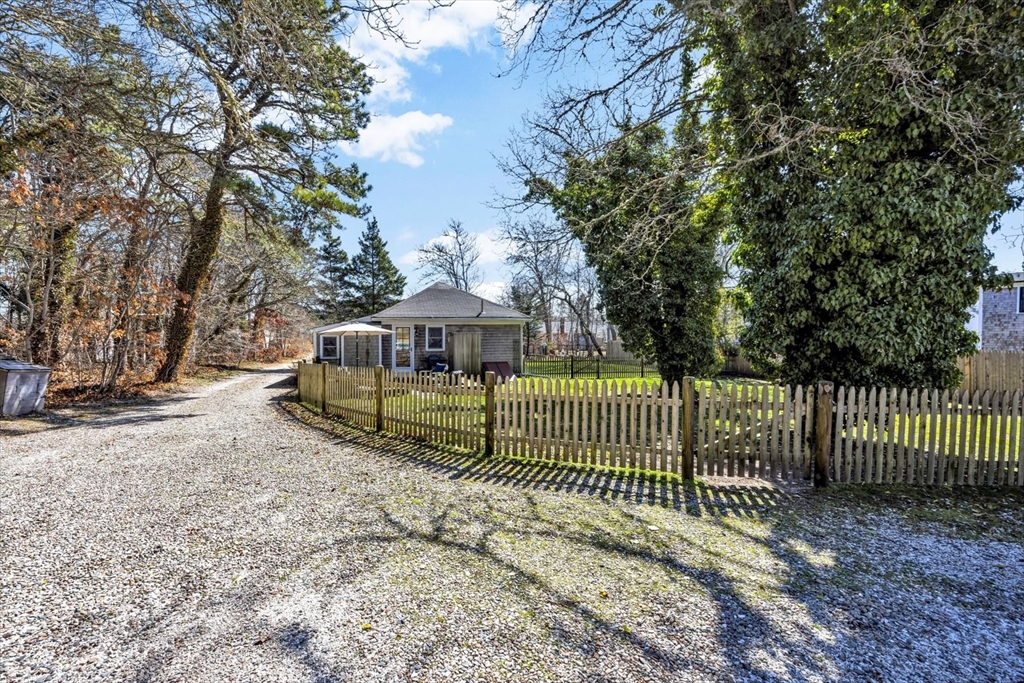 9 Jason Lane Harwich, MA 02646 - Photo 35 of 37 a view of a yard with wooden fence and trees