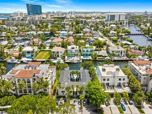 an aerial view of residential houses with city view