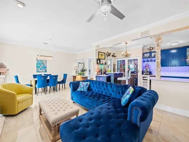 a living room with furniture a rug and a large window