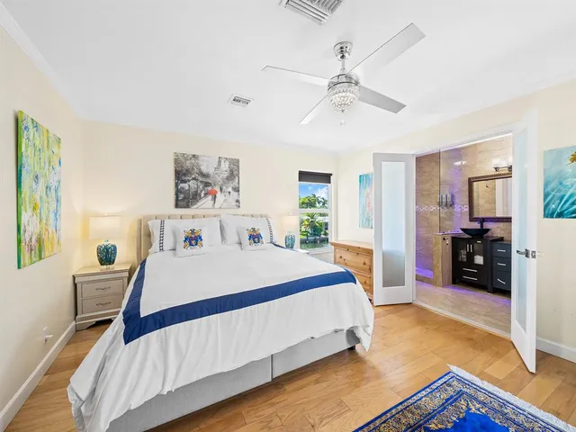 a bedroom with a bed and a chandelier