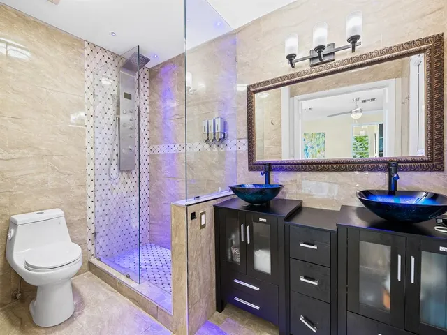 a bathroom with a toilet a sink and mirror