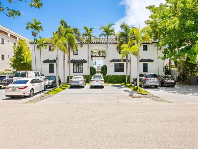 a car parked in front of yellow building