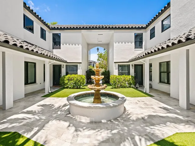a view of a white house with swimming pool in front of it