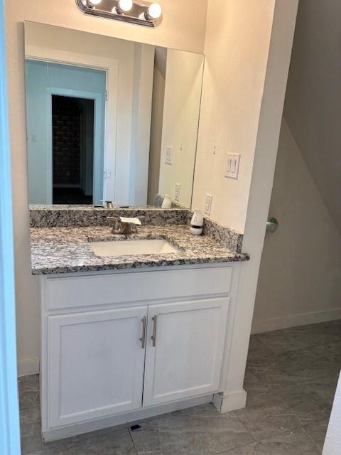 4209 Metropolitan Avenue Dallas, TX 75210 - Photo 12 of 16 a bathroom with a granite countertop sink and a mirror