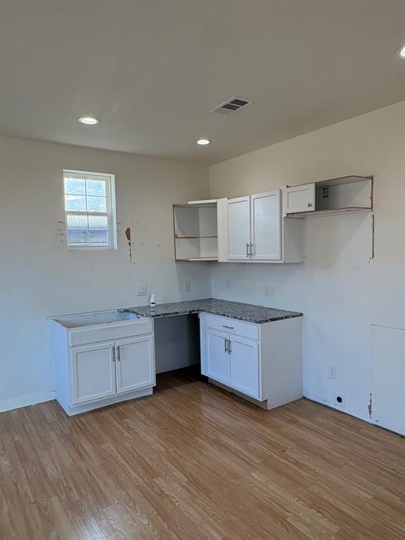 4209 Metropolitan Avenue Dallas, TX 75210 - Photo 4 of 16 a kitchen with granite countertop a sink cabinets and wooden floor