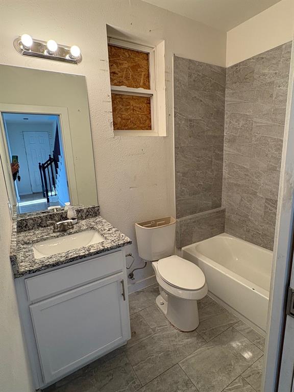 4209 Metropolitan Avenue Dallas, TX 75210 - Photo 6 of 16 a bathroom with a granite countertop toilet a sink and a mirror