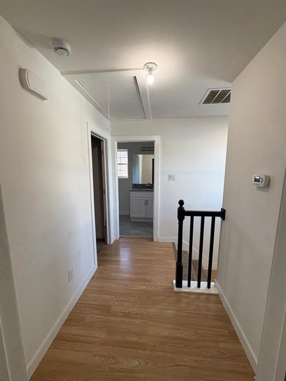 4209 Metropolitan Avenue Dallas, TX 75210 - Photo 9 of 16 a view of a hallway with wooden floor and entryway