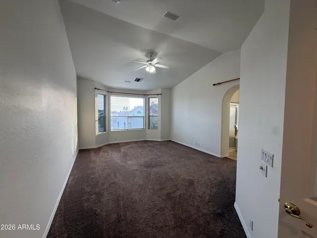 an empty room with windows and closet