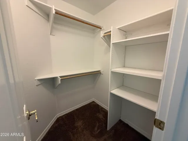 a view of walk in closet with empty racks