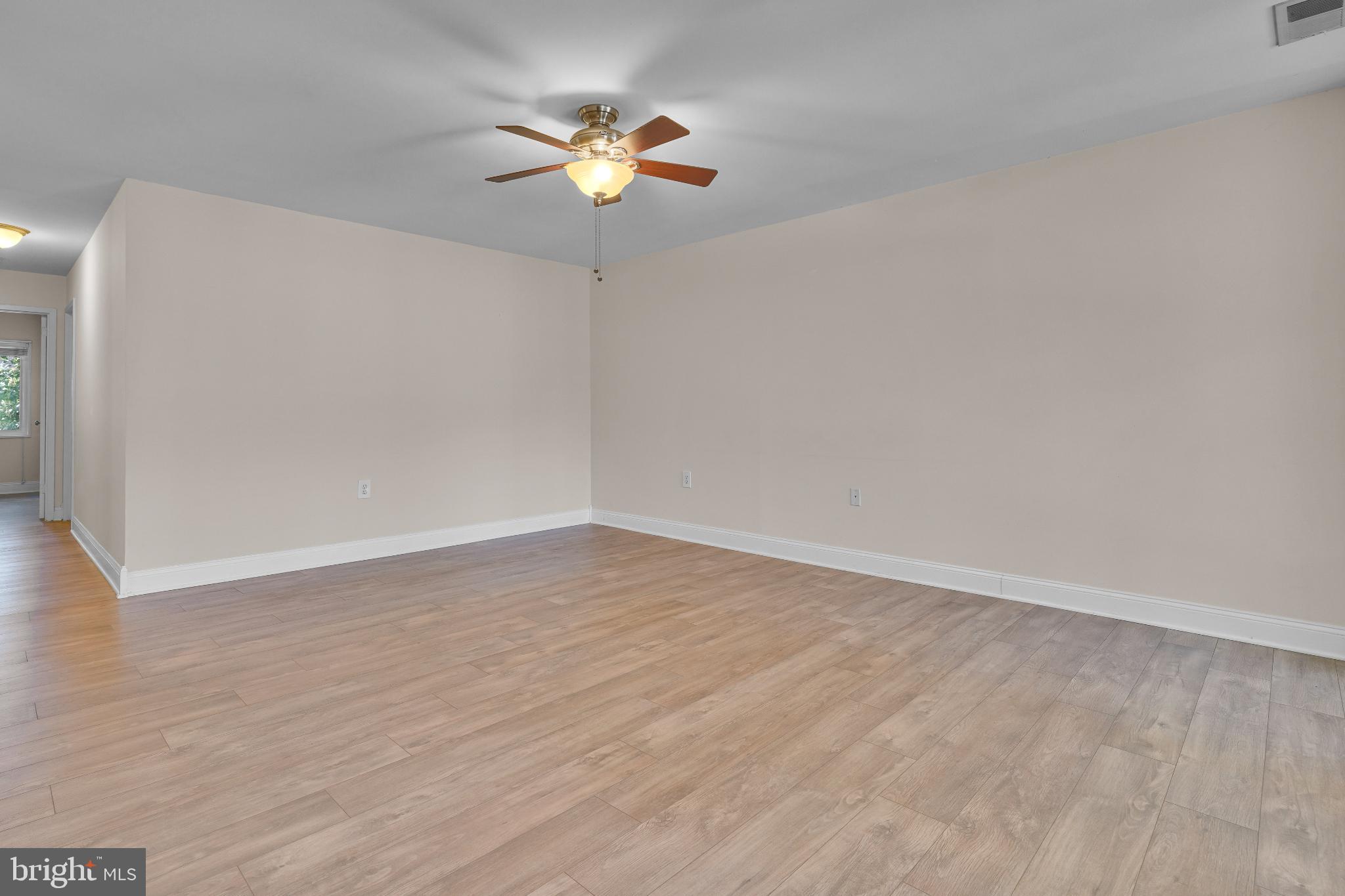 1439 Northgate Square, Unit 39/21B Reston, VA 20190 - Photo 13 of 23 an empty room with wooden floor and chandelier fan