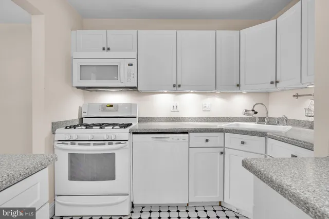 a kitchen with cabinets appliances and a sink