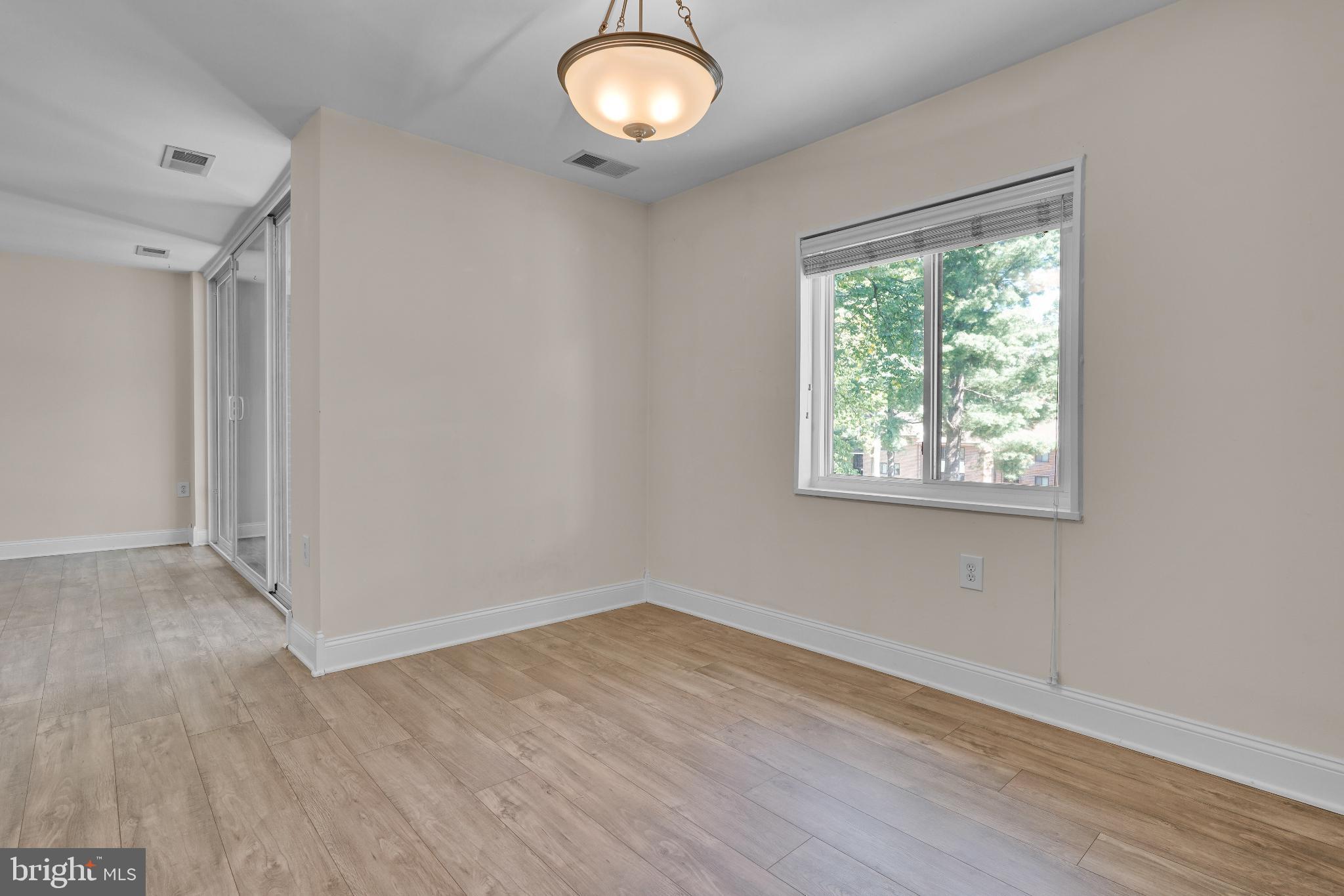 1439 Northgate Square, Unit 39/21B Reston, VA 20190 - Photo 18 of 23 an empty room with wooden floor and windows