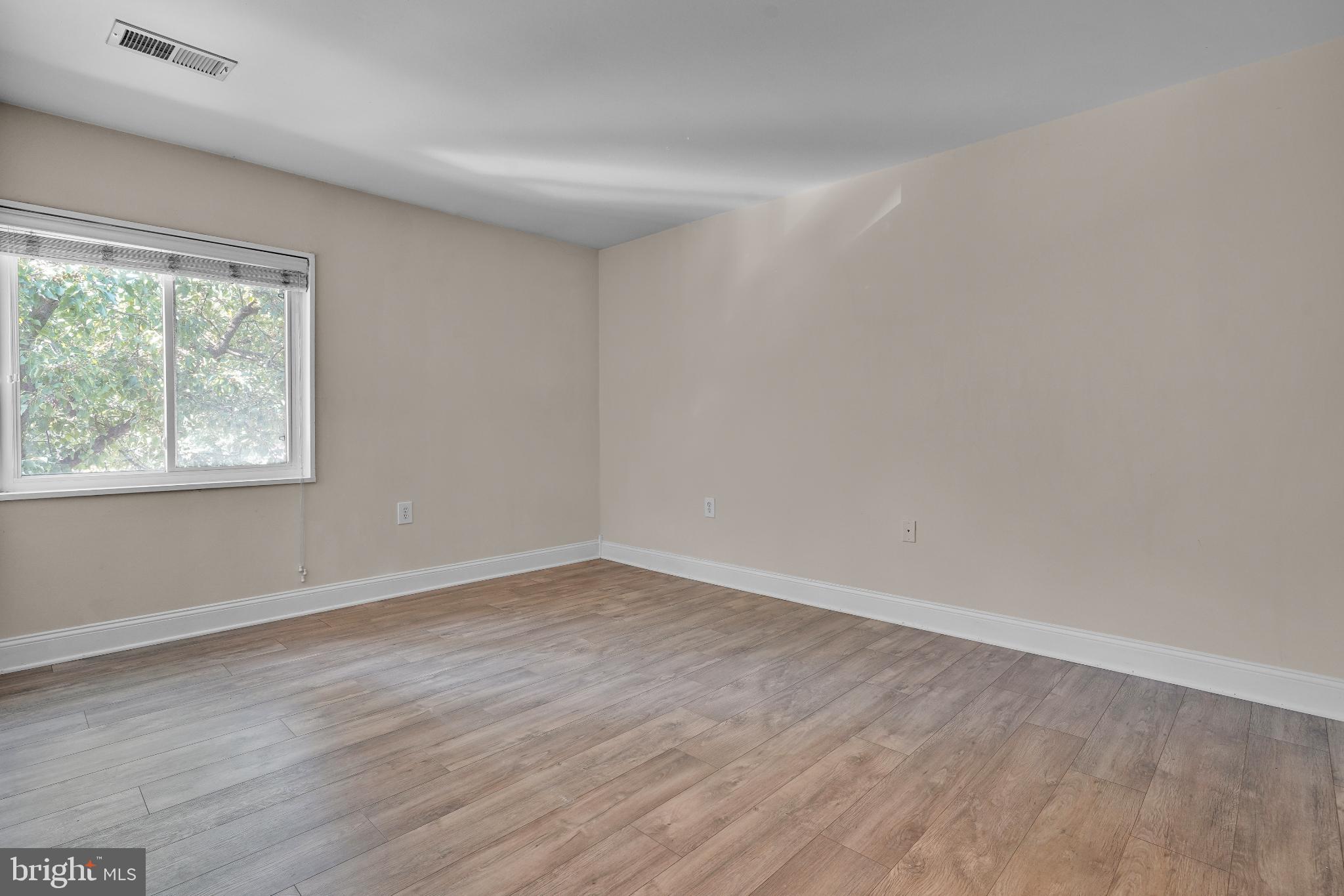 1439 Northgate Square, Unit 39/21B Reston, VA 20190 - Photo 23 of 23 a view of an empty room with wooden floor and a window