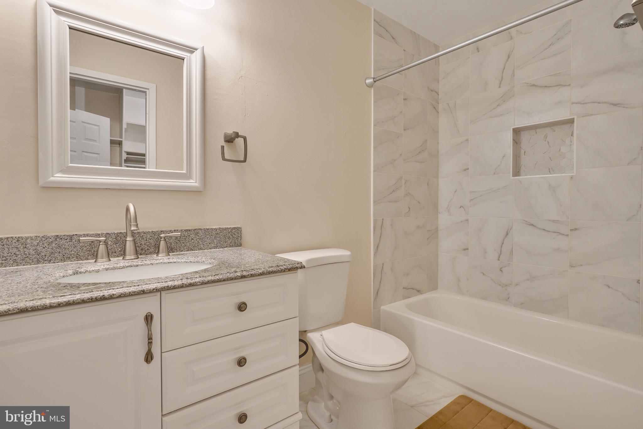 1439 Northgate Square, Unit 39/21B Reston, VA 20190 - Photo 5 of 23 a bathroom with a granite countertop sink toilet and shower