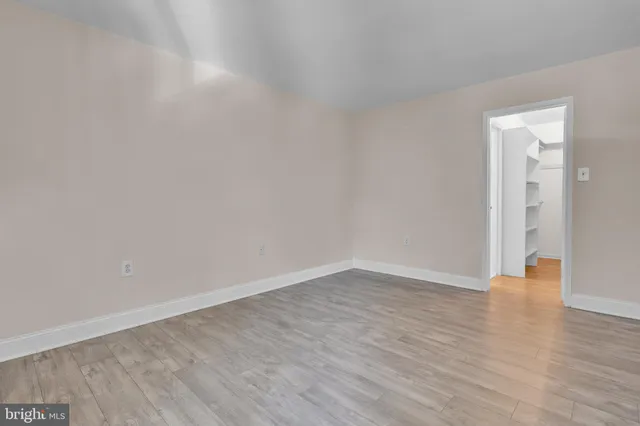a view of an empty room and wooden floor