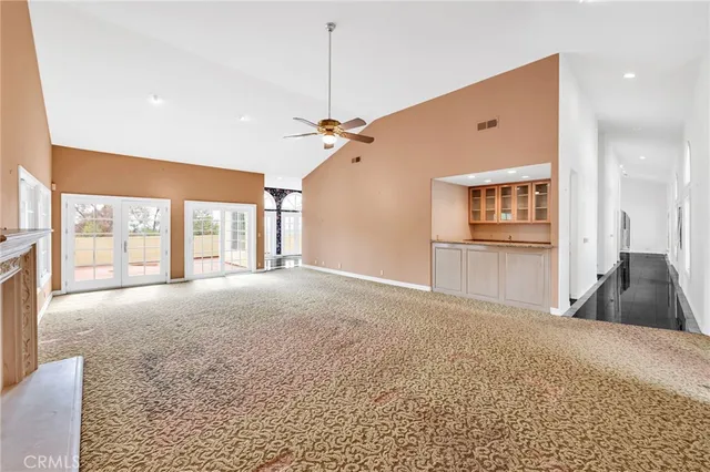 a kitchen with stainless steel appliances granite countertop a sink a stove and a wooden cabinets