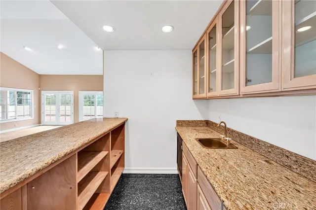 a view of a bedroom with wooden floor and windows