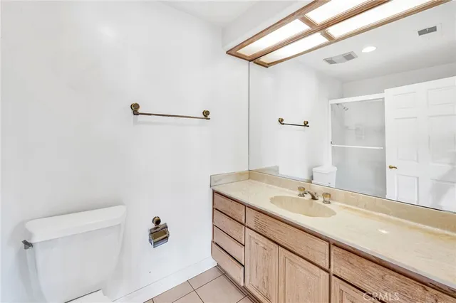 a bedroom with a large bed a flat screen tv and a couch