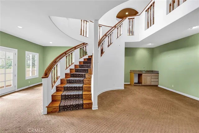 a view of empty room with floor to ceiling window and fireplace