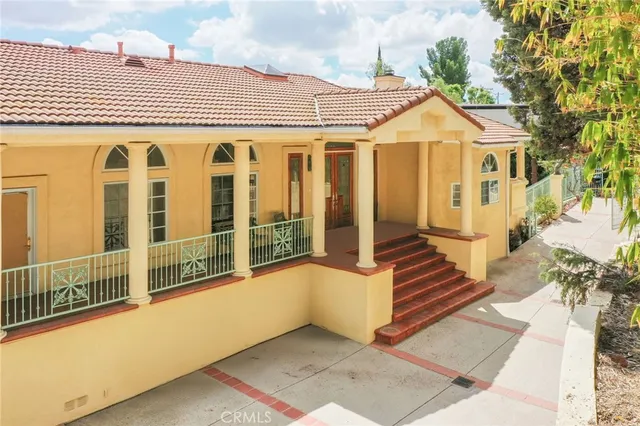 a living room with furniture a large window and a fireplace