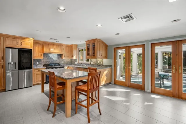 a kitchen with stainless steel appliances kitchen island granite countertop a sink and cabinets