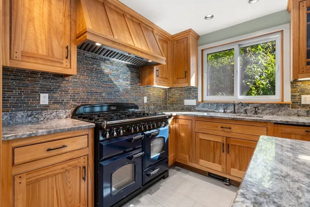 a living room with stainless steel appliances granite countertop furniture and a kitchen view