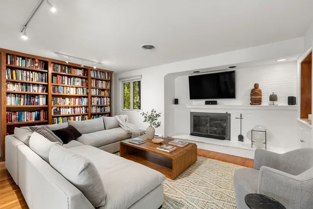 a bedroom with furniture and a large window