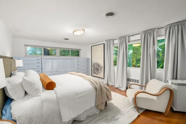 a bedroom with a bed couch and window