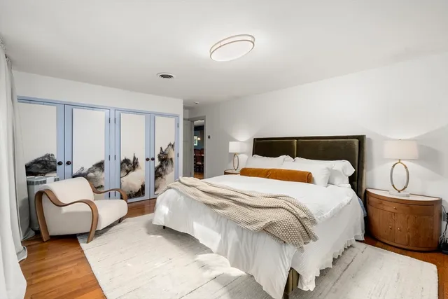 a bathroom with a granite countertop sink and a large mirror
