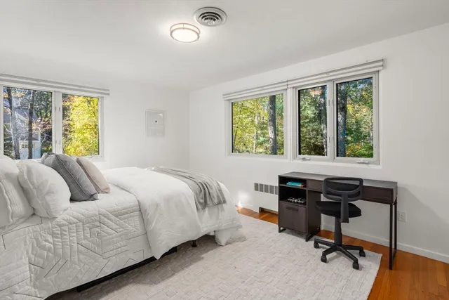 a bedroom with a bed and a chair