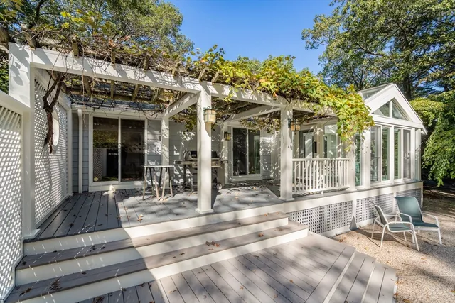 a view of swimming pool with lawn chairs and plants