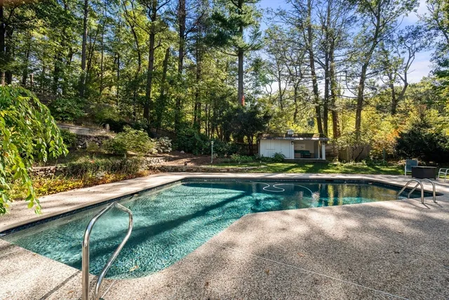 a view of a chair and table in backyard of the house