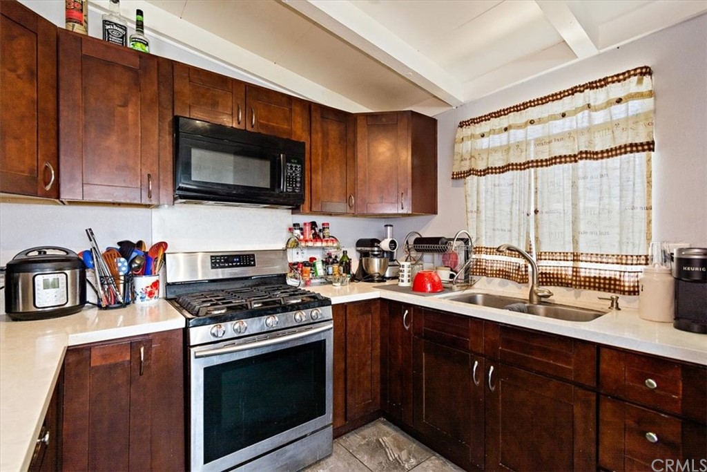 3510 McKenzie Street Riverside, CA 92503 - Photo 12 of 27 a kitchen with stainless steel appliances a sink a stove a microwave and cabinets