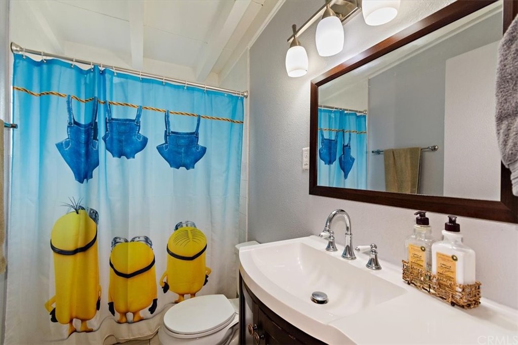 3510 McKenzie Street Riverside, CA 92503 - Photo 15 of 27 a bathroom with a sink mirror vanity and toilet