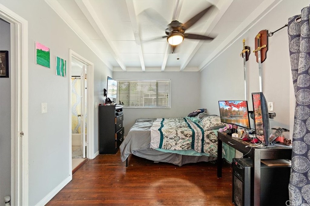 3510 McKenzie Street Riverside, CA 92503 - Photo 17 of 27 a bedroom with a bed and a chandelier