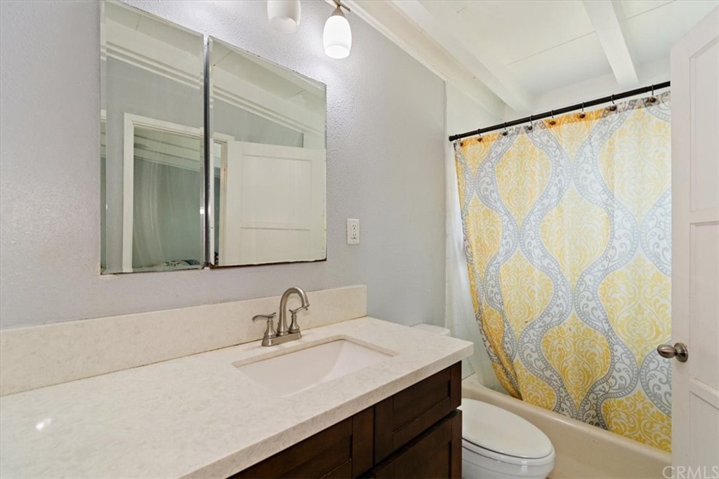3510 McKenzie Street Riverside, CA 92503 - Photo 19 of 27 a bathroom with a granite countertop sink and a mirror