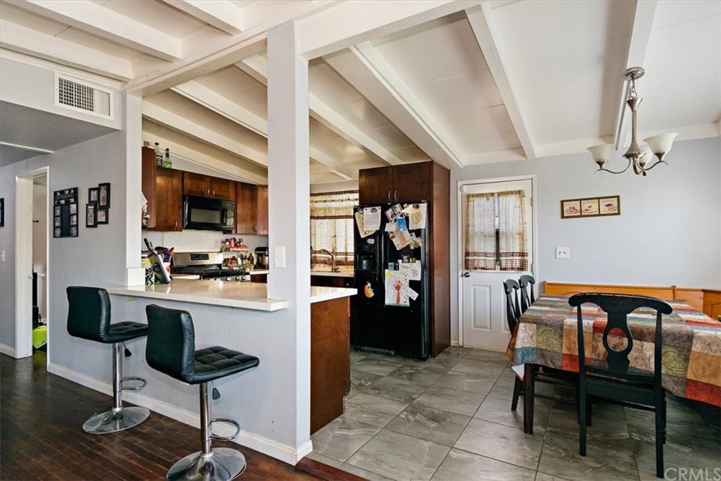3510 McKenzie Street Riverside, CA 92503 - Photo 9 of 27 a living room with furniture a rug and kitchen view