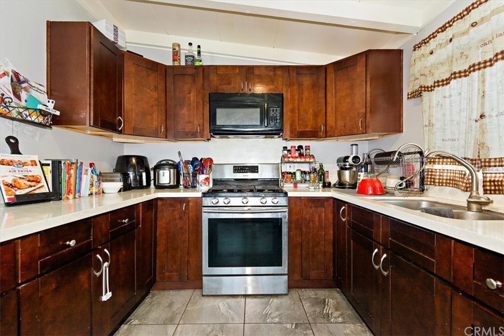 3510 McKenzie Street Riverside, CA 92503 - Photo 10 of 27 a kitchen with stainless steel appliances granite countertop a sink stove and microwave