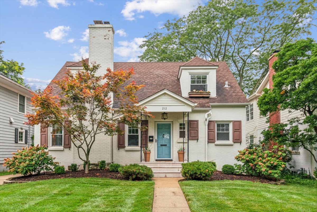 212 E Road Glen Ellyn, IL 60137 - Photo 1 of 42 a front view of a house with a garden and plants